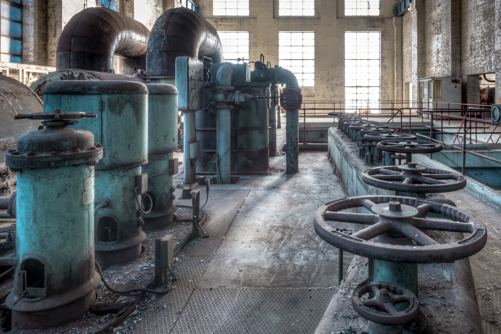 Valve Nest at White Bay Power Station, a row of cast-iron valve wheels lines the operator level of White Bay Power.