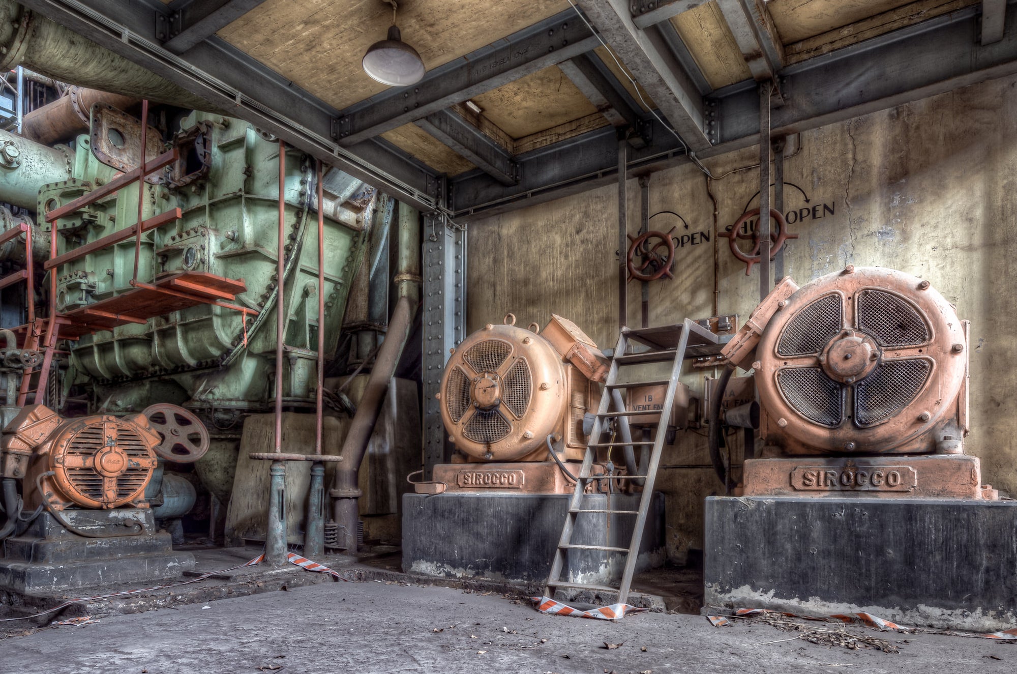Vent Fans at White Bay Power Station, two Sirocco centrifugal fans sit bolted to concrete plinths, their cast-iron housings.