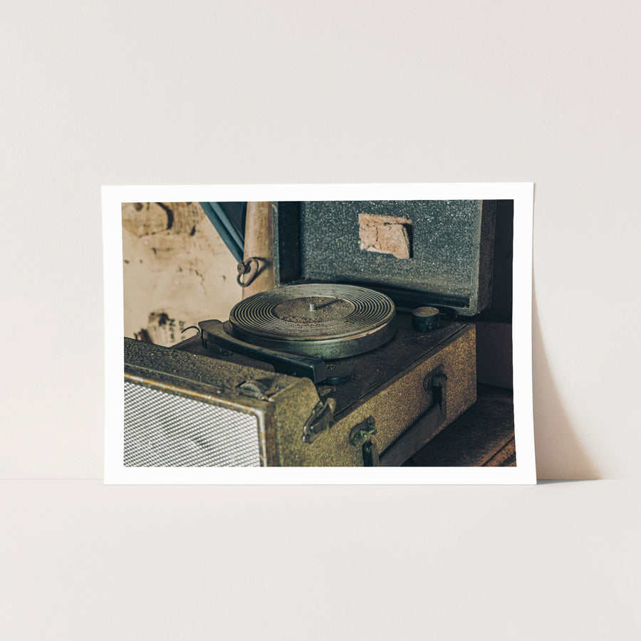 An open portable record player with a dusty ribbed metal turntable and worn fabric case, photographed in the Deua River Valley.