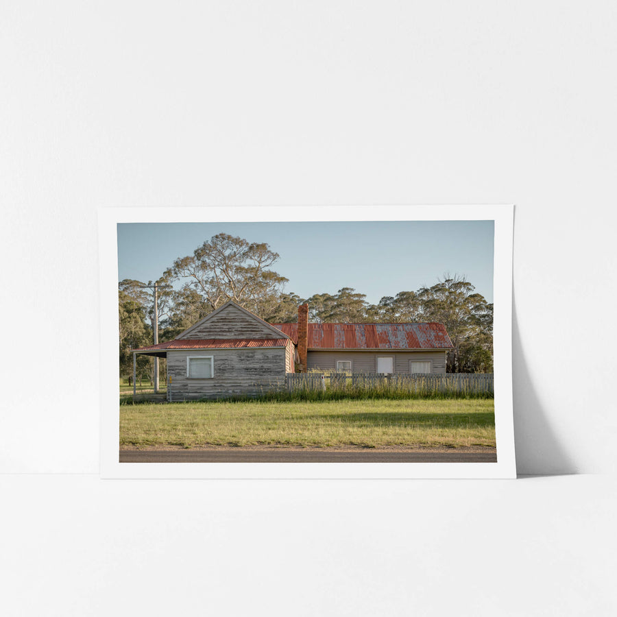 Cathcart Corner at A Place to Call Home, an old, red-roofed timber weatherboard house on the corner of a Cathcart Street.