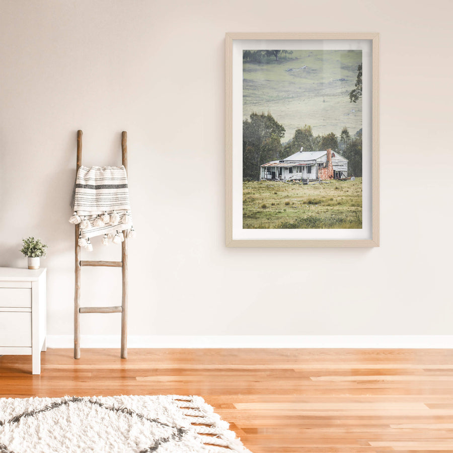 Home In The Valley at A Place to Call Home, a weatherboard farmhouse sits alone in open grazing country.