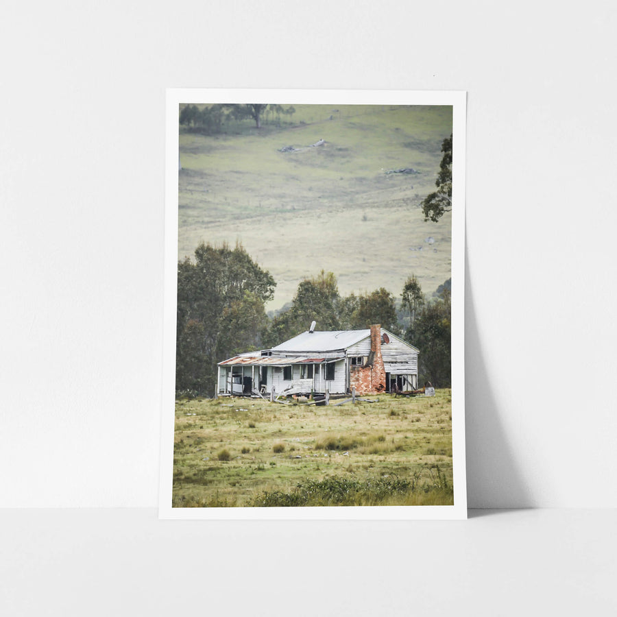 Home In The Valley at A Place to Call Home, a weatherboard farmhouse sits alone in open grazing country.