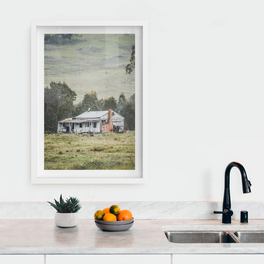 Home In The Valley at A Place to Call Home, a weatherboard farmhouse sits alone in open grazing country.