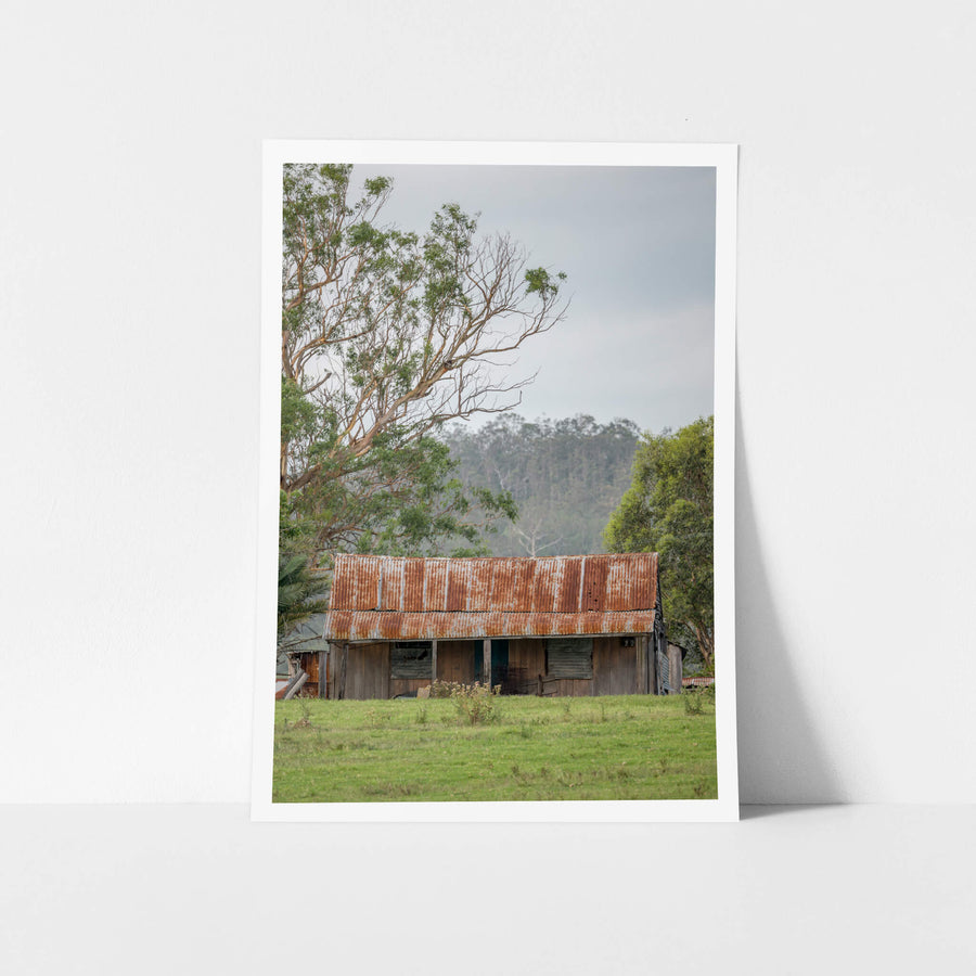 Hunter Hilltop at A Place to Call Home, a low timber shed sits in open green pasture beneath an overcast sky.