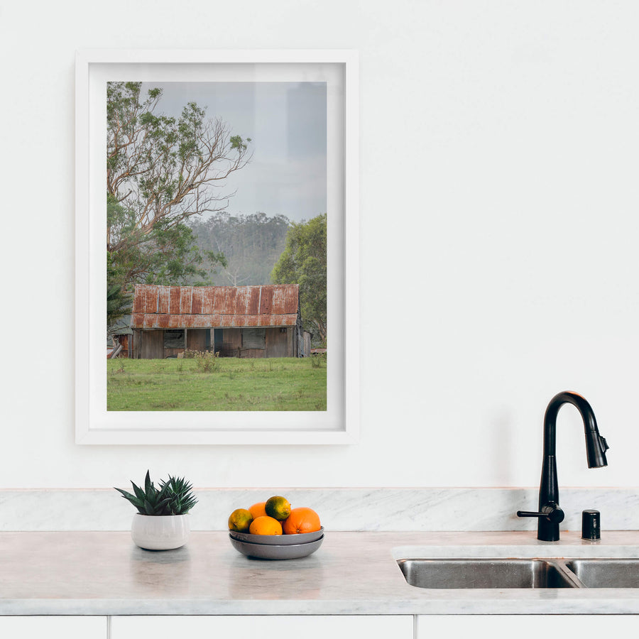 Hunter Hilltop at A Place to Call Home, a low timber shed sits in open green pasture beneath an overcast sky.