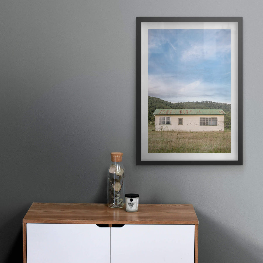 Hunter Shack at A Place to Call Home, a single-storey weatherboard building sits low in a clearing of dry grass and thistles.