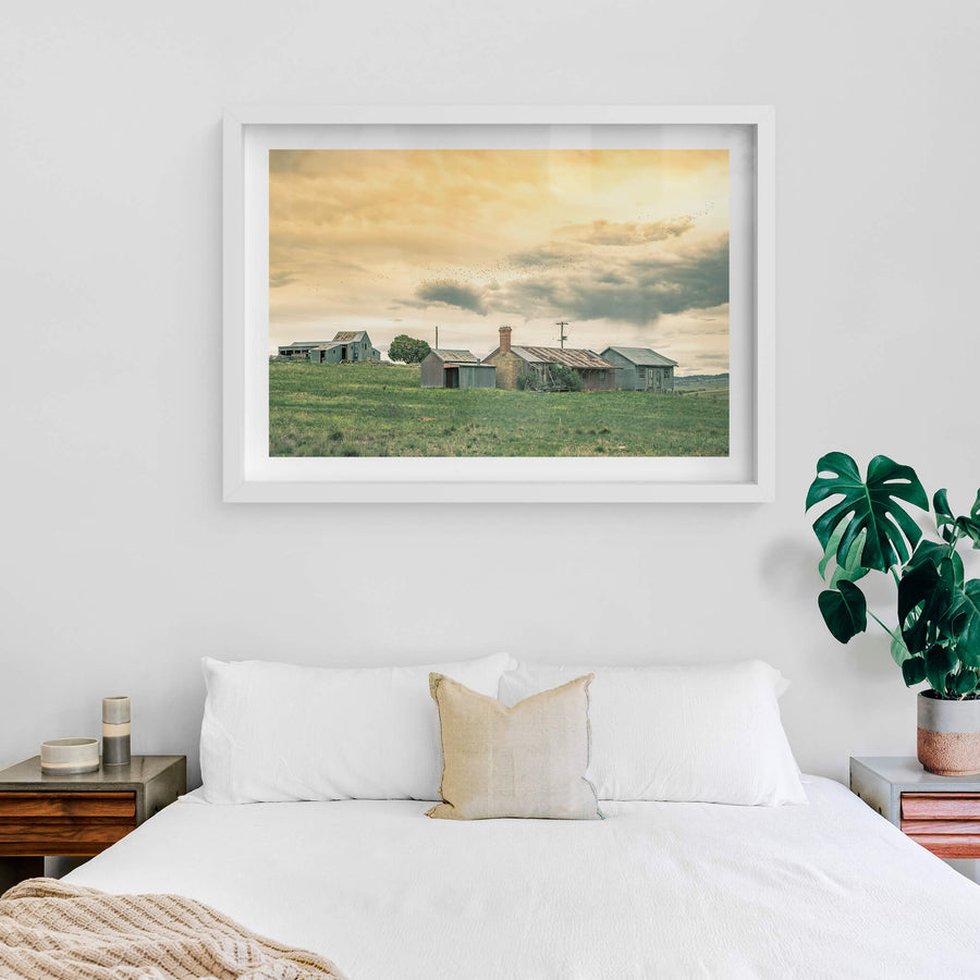 Numbla Vale Cottages & Woolshed at A Place to Call Home, a flock of birds flying above a cluster of farm workers cottages.