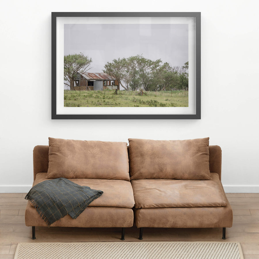 Rocky Hall Hills Hut at A Place to Call Home, a small rural structure sits on a low green rise near Rocky Hall Hills.