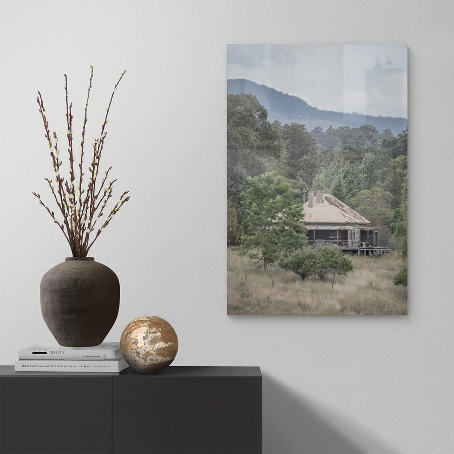 Wyndam Home at A Place to Call Home, a weatherboard homestead sits low in dry grass, its hipped roof a patchwork of rust.
