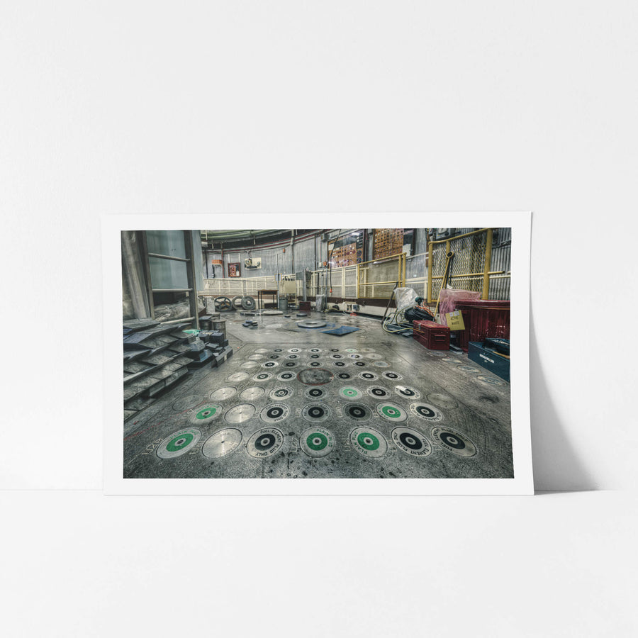 No 1 Storage Block at ANSTO HIFAR, dozens of circular plugs are set into the reactor's charge face, each stamped "FUEL.