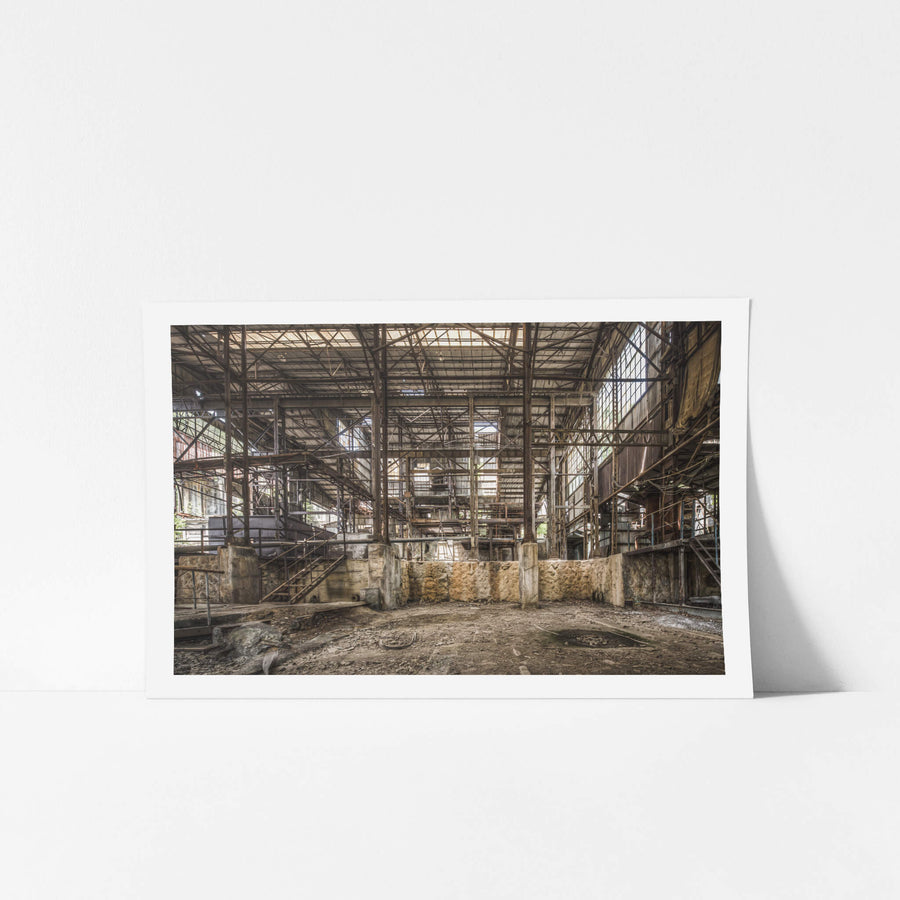 Void at Ashio Copper Mine, steel trusses span the full width of the processing hall, rising three storeys above a bare.