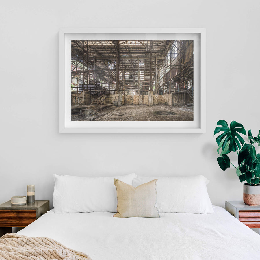 Void at Ashio Copper Mine, steel trusses span the full width of the processing hall, rising three storeys above a bare.