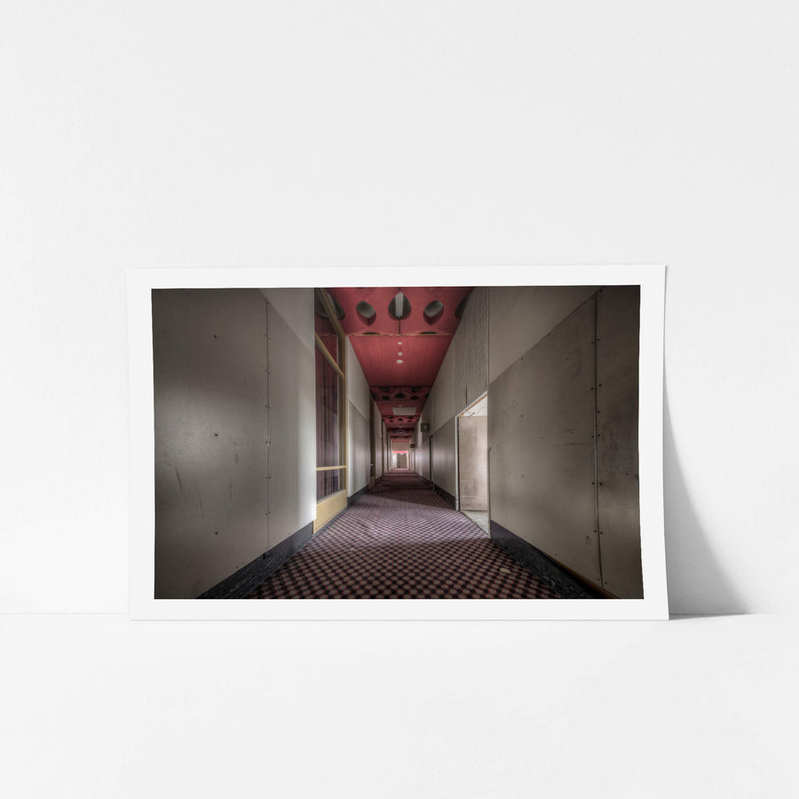 Auditorium Corridor at Bankstown RSL, a long corridor stretches deep into the building, narrowing to a vanishing point lit.