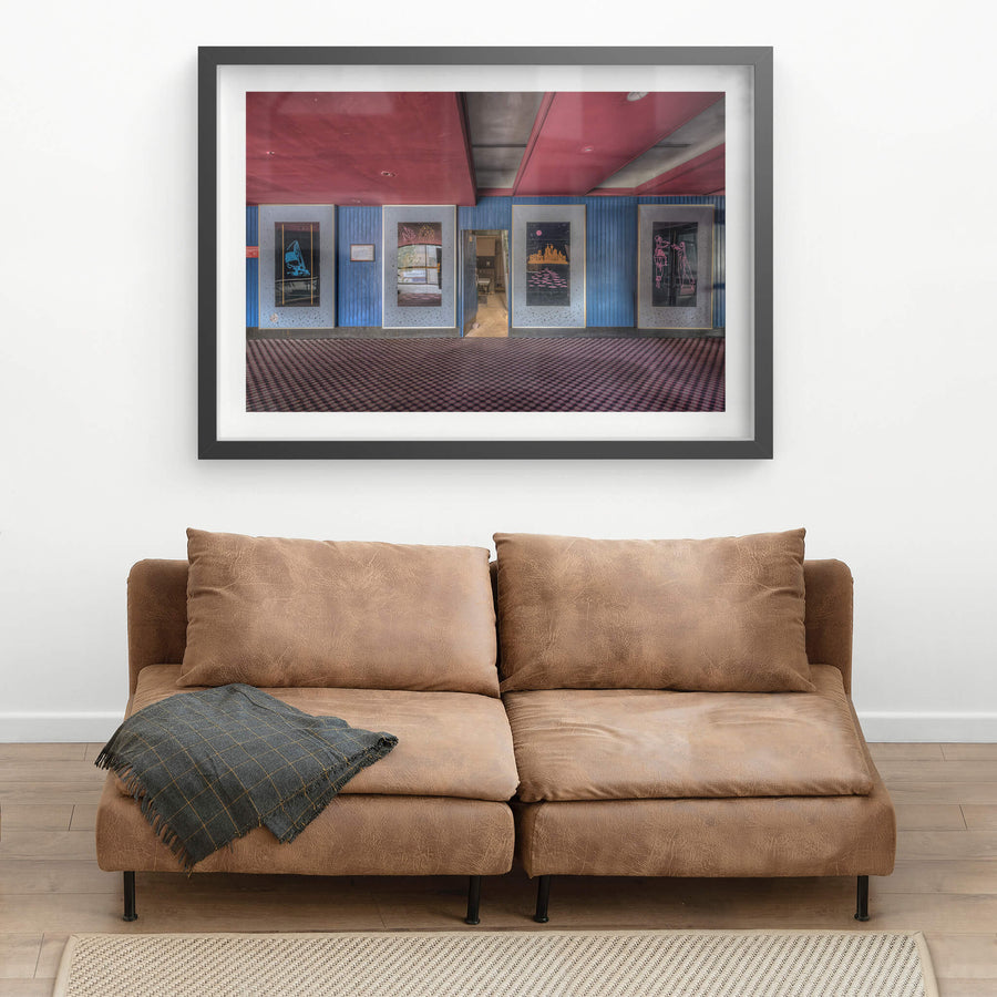 Foyer Art at Bankstown RSL, five framed artworks line the foyer wall, mounted on blue timber panelling punctuated.