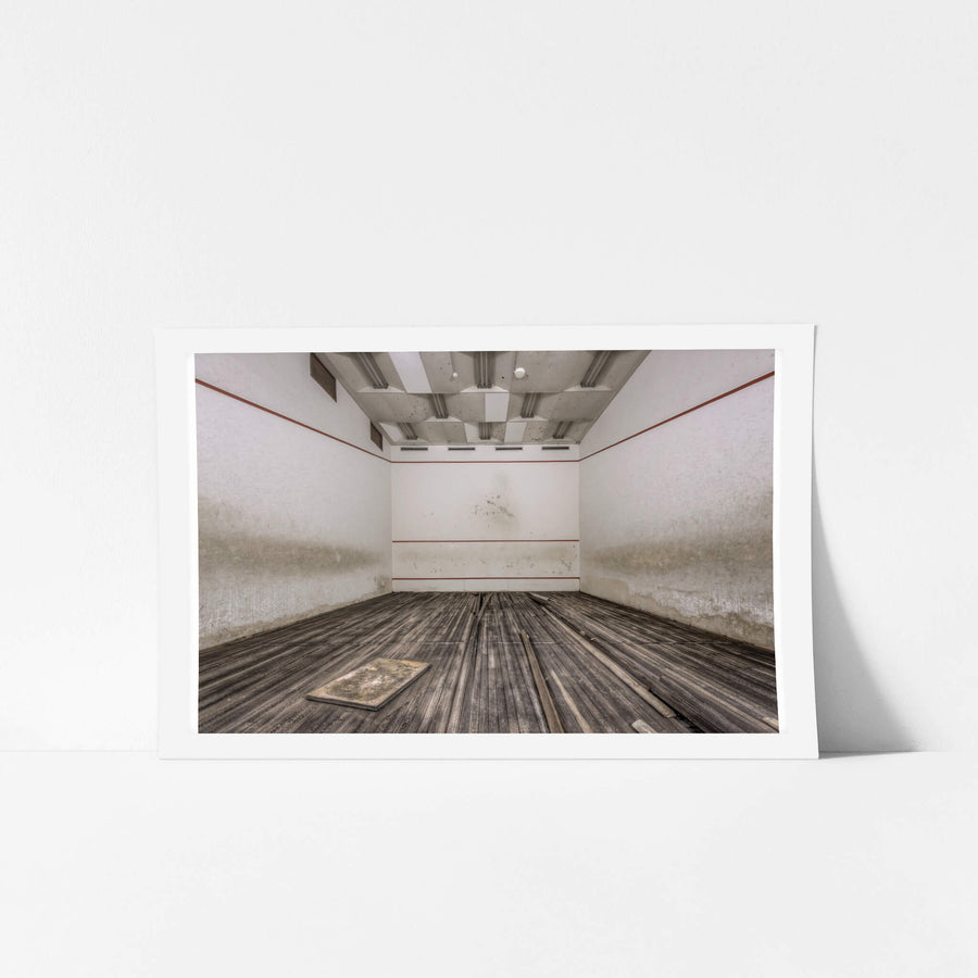 Squash Court at Bankstown RSL, the hardwood floor has buckled and warped, planks lifting away from the subfloor in long.