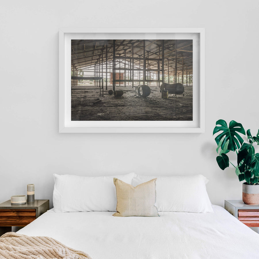 Top Holding Area at Blayney Abattoir, steel columns support a wide corrugated roof over a dirt floor thick with dried mud.