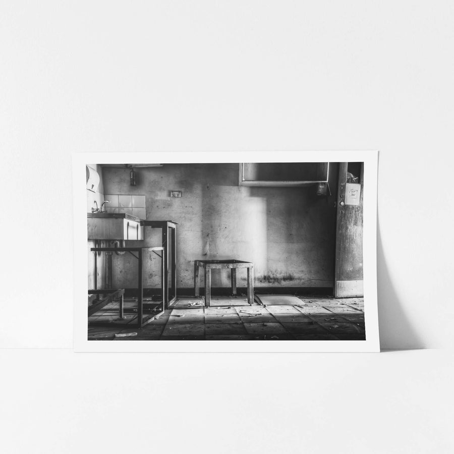 Wash Room at Blayney Abattoir, a shaft of light falls through an open window onto cracked floor tiles.