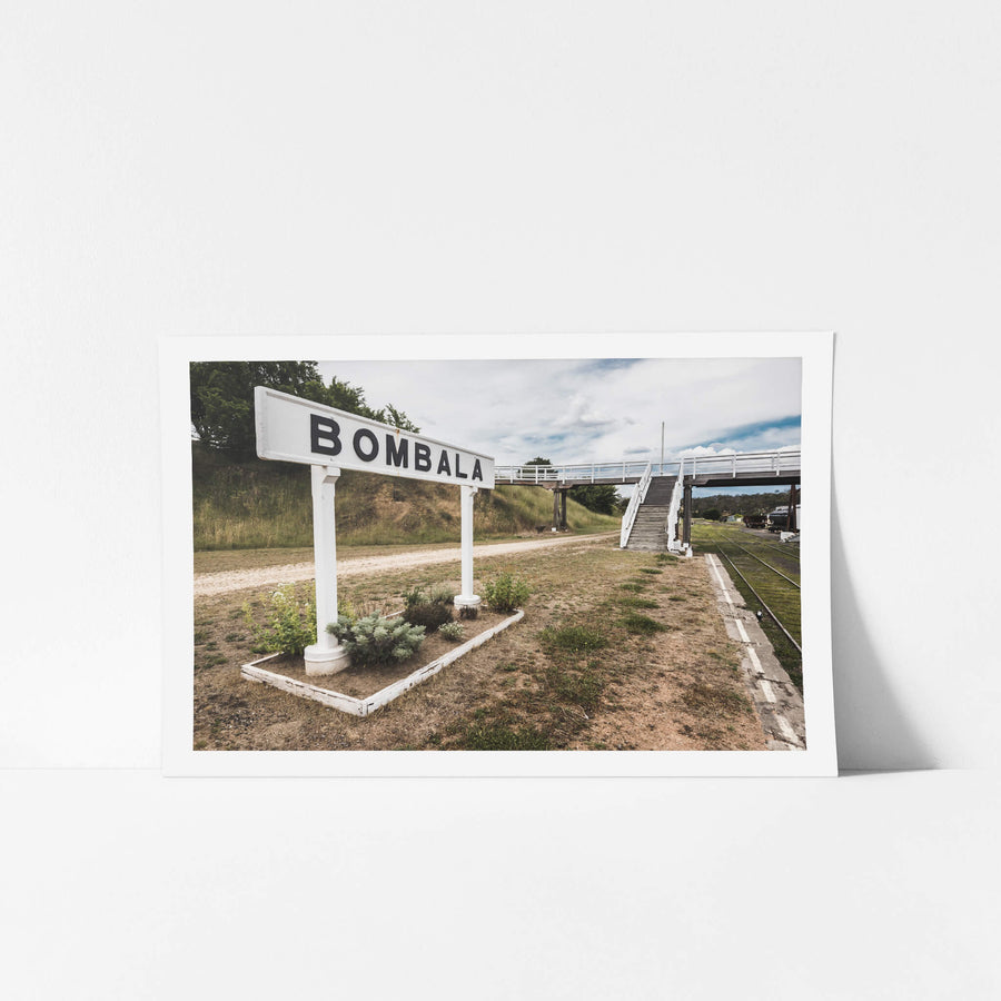 Bombala at Bombala Station, the white timber station sign stands at platform level, bold black letters spelling BOMBALA.