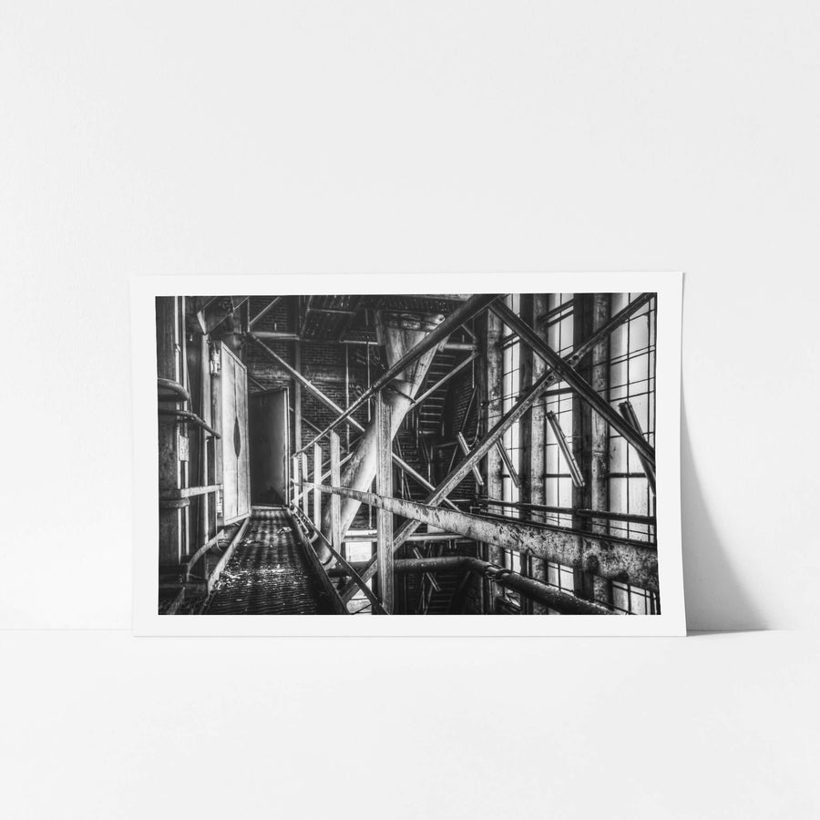 Boiler House Walkway at Bradmill Denim, steel cross-bracing and diagonal pipes cut across a narrow elevated walkway inside.