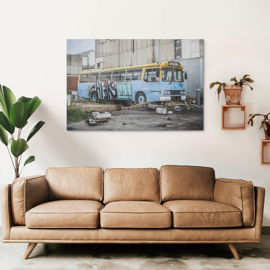Bus at Bradmill Denim, a decommissioned bus sits against corrugated steel cladding in a yard at the Bradmill site.