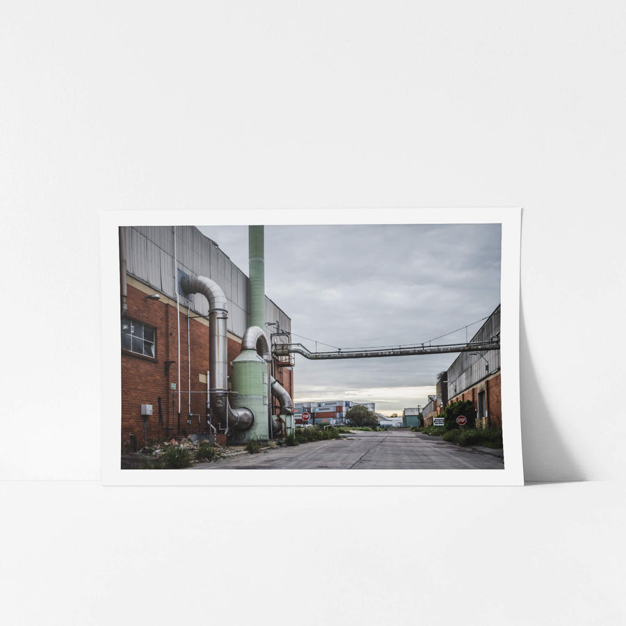 Chemical Plant at Bradmill Denim, a green dust extraction unit stands bolted to the red brick facade of a factory building.