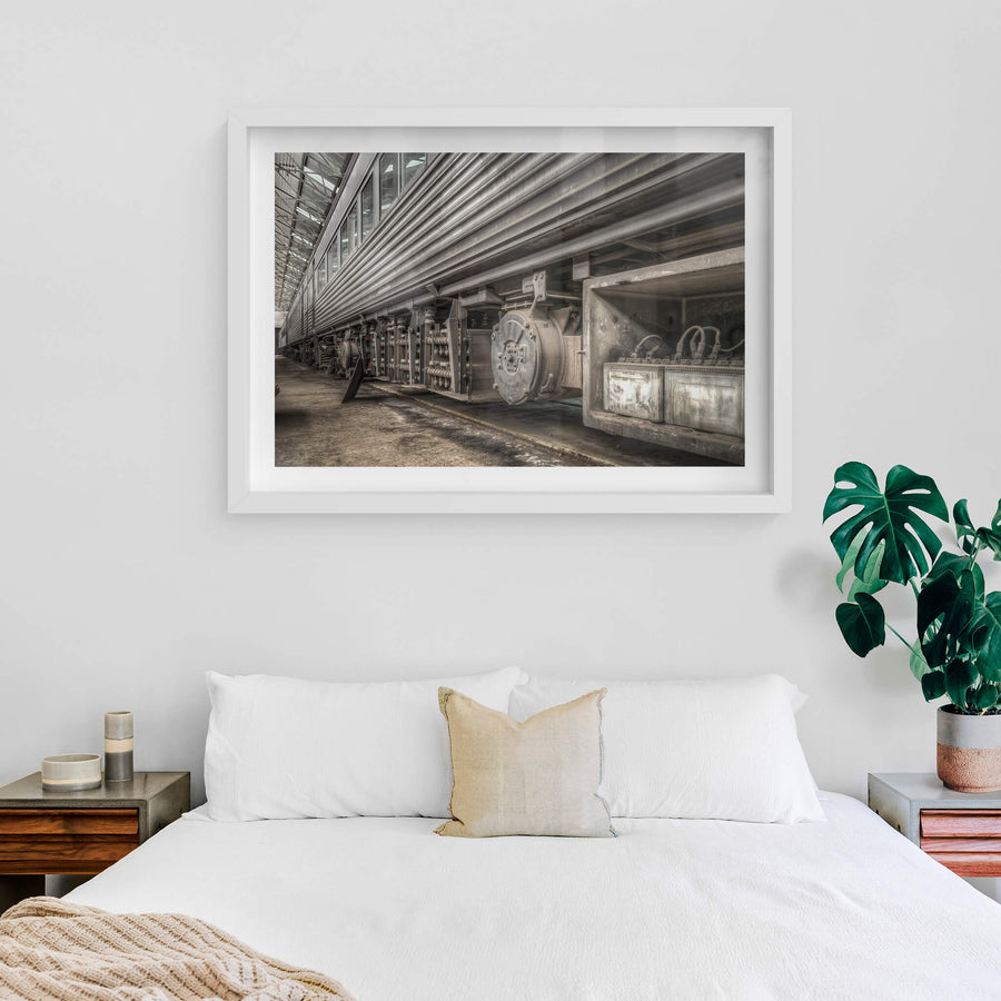 Batteries at Eveleigh Paint Shop, the underside of a stainless steel interurban carriage fills the frame.