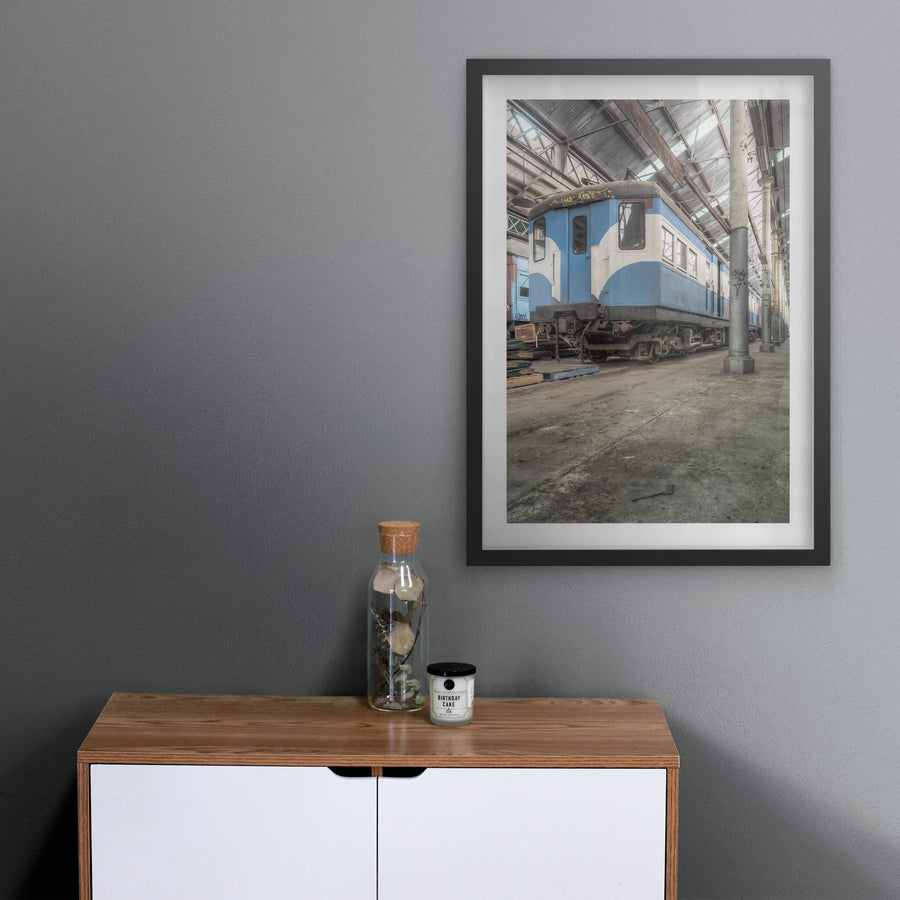 Phillip Shirley at Eveleigh Paint Shop, a blue and white railway carriage sits on bare concrete inside the Eveleigh Paint Shop.