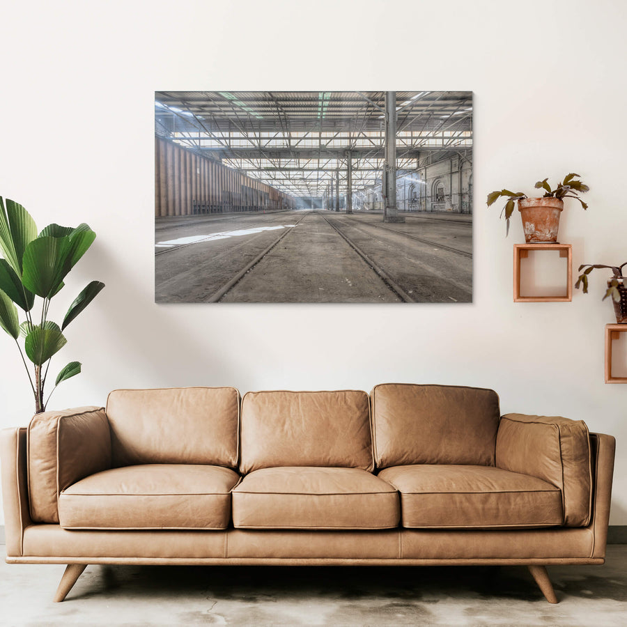 Suburban Car Workshop Facing East at Eveleigh Paint Shop, light spills through the sawtooth roof, filtering through layers of steel and glass to cast long shadows across the dust-laden floor.