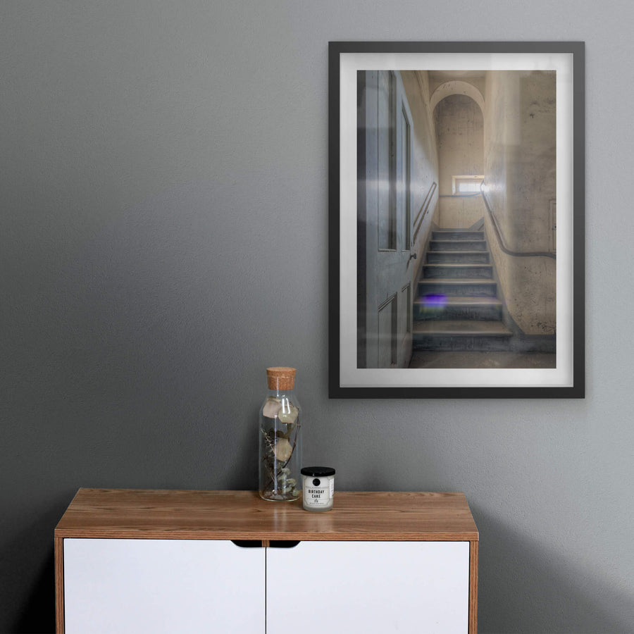 Flare at Female Ward 9 & 10, a narrow stairwell climbs between plaster walls stained grey and ochre with damp.