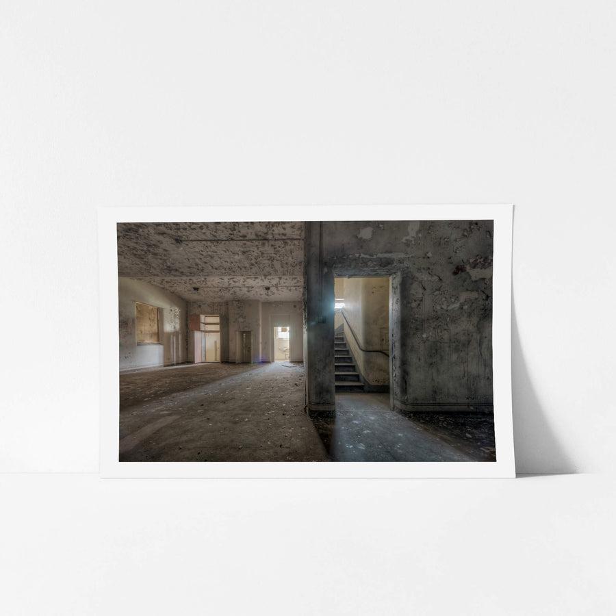 Split at Female Ward 9 & 10, a wall dividing the main area of the ward and a staircase to upper levels.