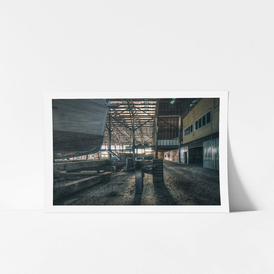 Boat Stands at Halvorsens Boat Yard, a timber hull sits raised on keel blocks inside the main construction shed.