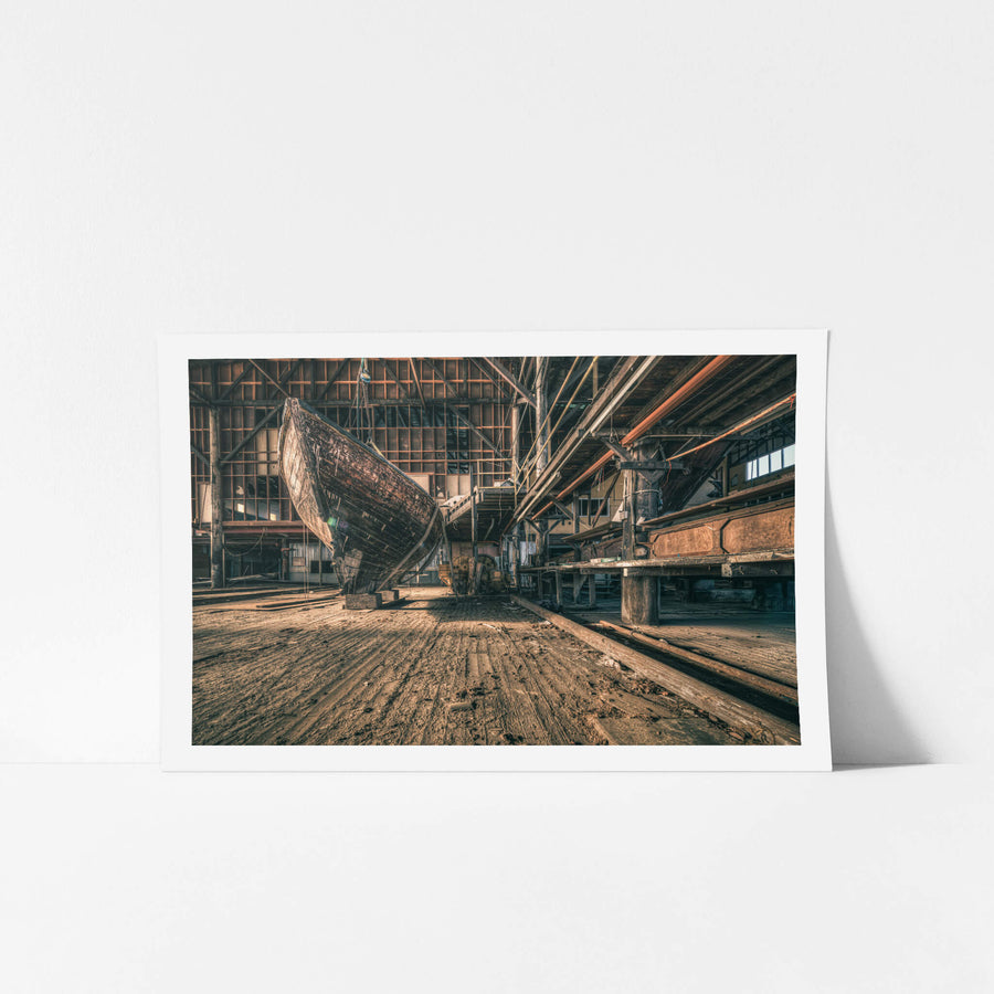 Hull at Halvorsens Boat Yard, a timber hull sits propped on blocks inside the main construction shed.