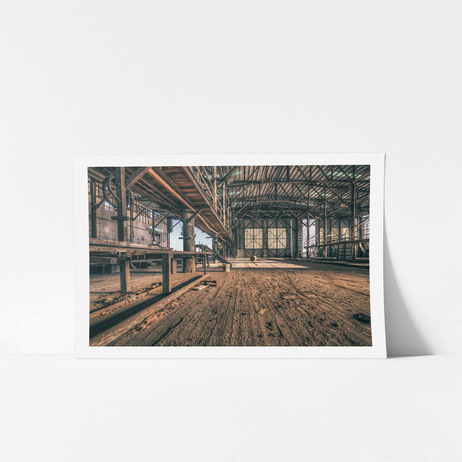 Workshop Floor at Halvorsens Boat Yard, worn timber planks stretch the full length of the workshop floor, their grain split.