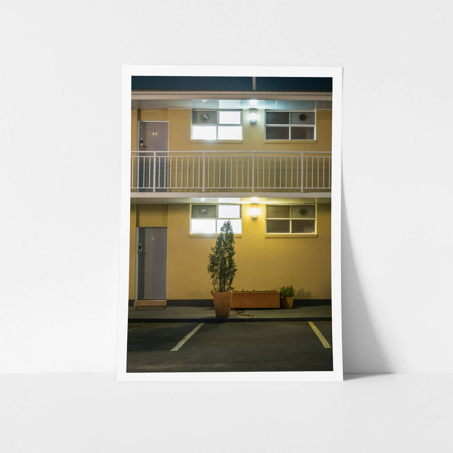 Comfort Inn North Shore at Hotel Motel 101, two storeys of mustard-yellow rendered wall, divided by a white steel.