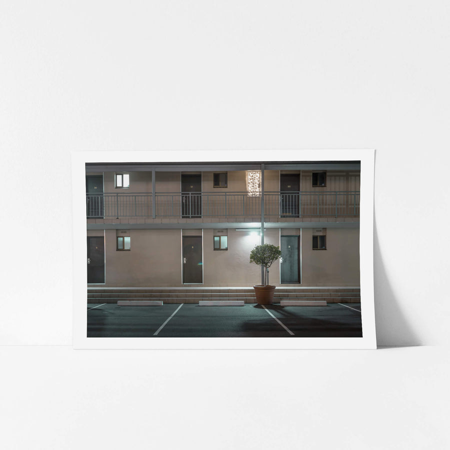 Galaxy Motel at Hotel Motel 101, two storeys of rendered masonry and blockwork face an empty car park.