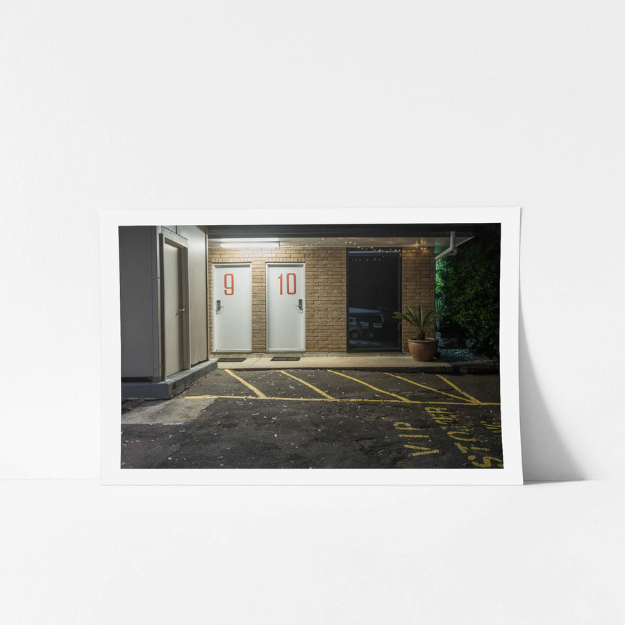 Jamison Hotel at Hotel Motel 101, rooms 9 and 10 sit side by side behind white doors marked with large red numerals.