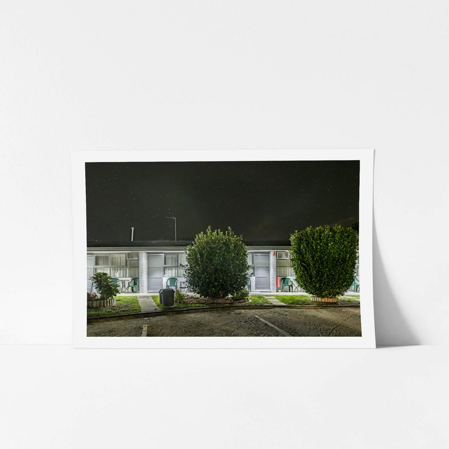 Mittagong Motel at Hotel Motel 101, two white-painted brick units sit side by side under a dark sky thick with stars.