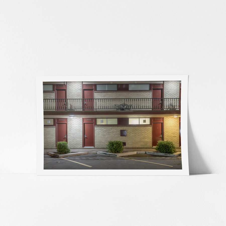 Red Star Hotel at Hotel Motel 101, two storeys of cream brick and dark red doors.