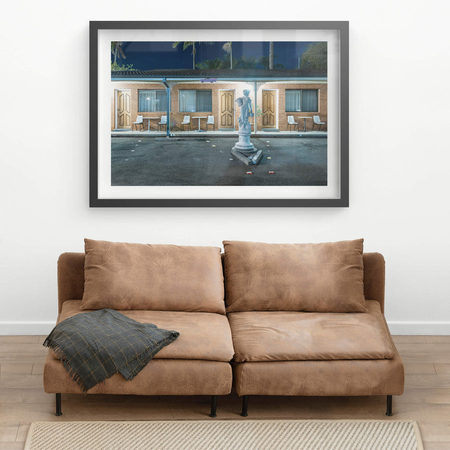 Sapphire Palms Motel, The Entrance at Hotel Motel 101, a statue stands in the motel carpark with palm trees rising behind.