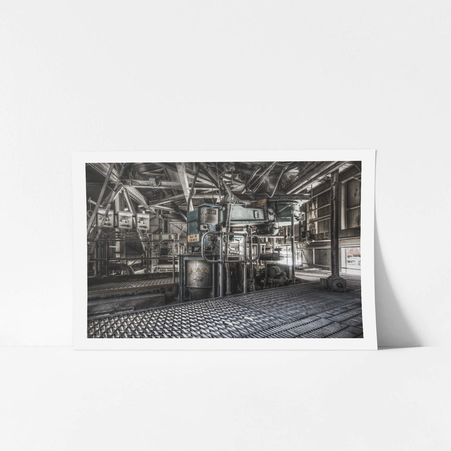 Weigh Feeder at Kandos Cement Works, steel grating covers the floor, its diamond-pattern surface worn dark withite dust.