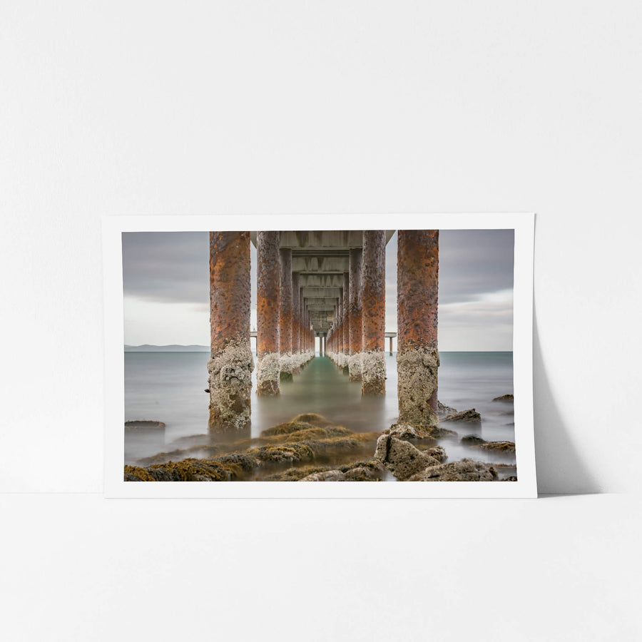 Lorne Pier at Landscapes, the barnacle-encrusted pylons of Lorne Pier extending off the shore.