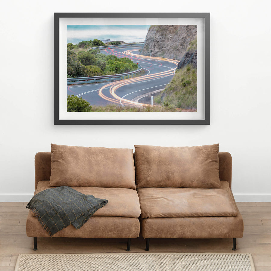 Meander at Landscapes, the Great Ocean Road winds through a cutting in the coastal rock face, the asphalt banking hard.