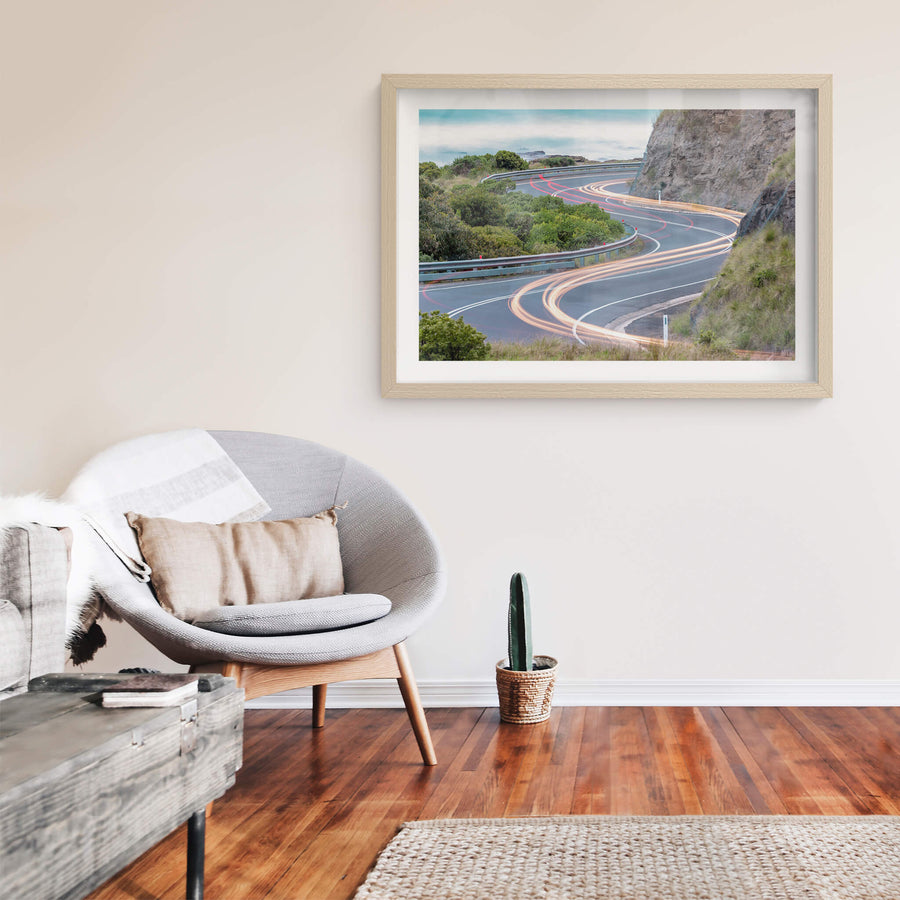 Meander at Landscapes, the Great Ocean Road winds through a cutting in the coastal rock face, the asphalt banking hard.