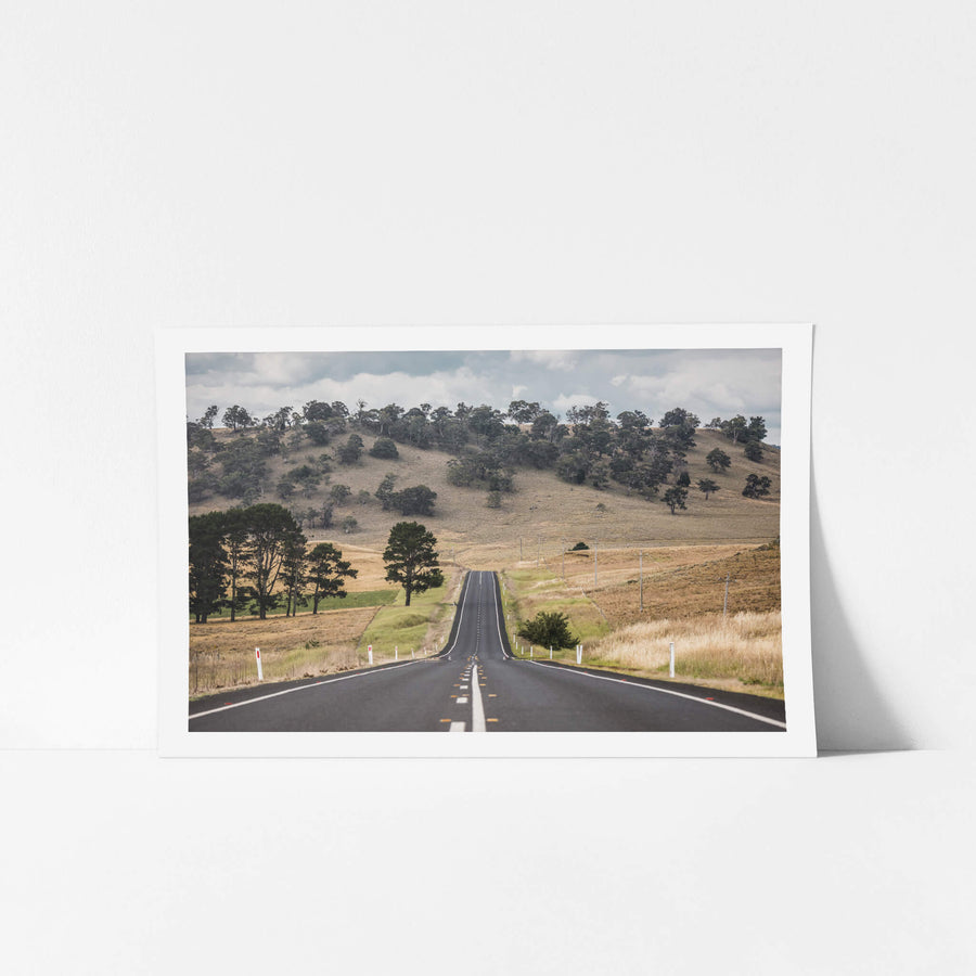 Monaro Highway at Landscapes, a road that rises and falls with the land, carving a path through the rolling hills.