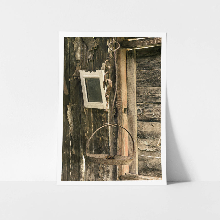 Hanging Scale at Leichhardt House, a rusted iron scale hangs from a heavy chain and ring bolt fixed to the exterior wall.