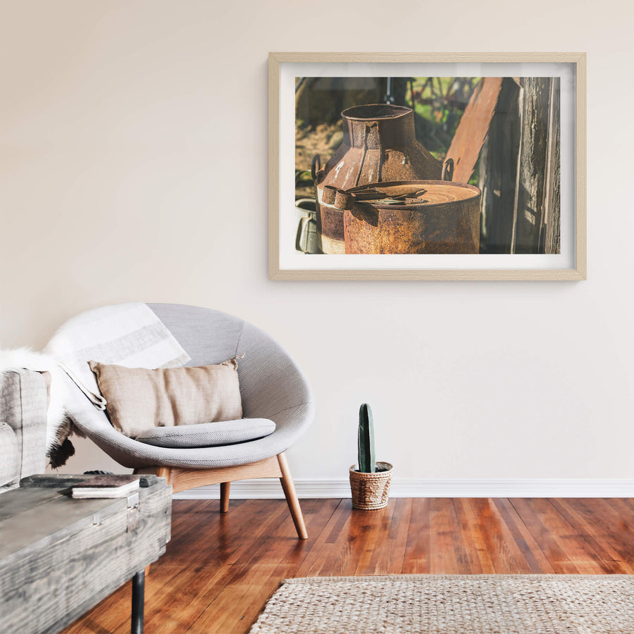 Rust at Leichhardt House, two steel milk cans sit against a weathered timber wall.