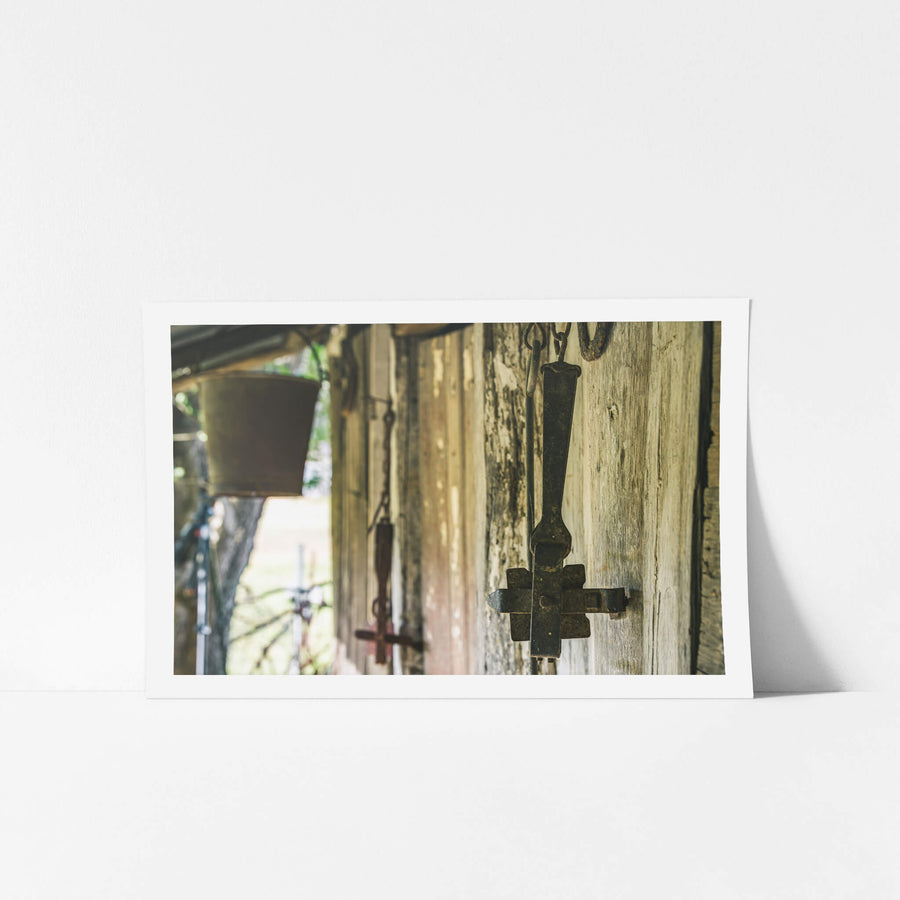 Traps at Leichhardt House, cast iron branding irons hang from hooks driven into weathered hardwood cladding.