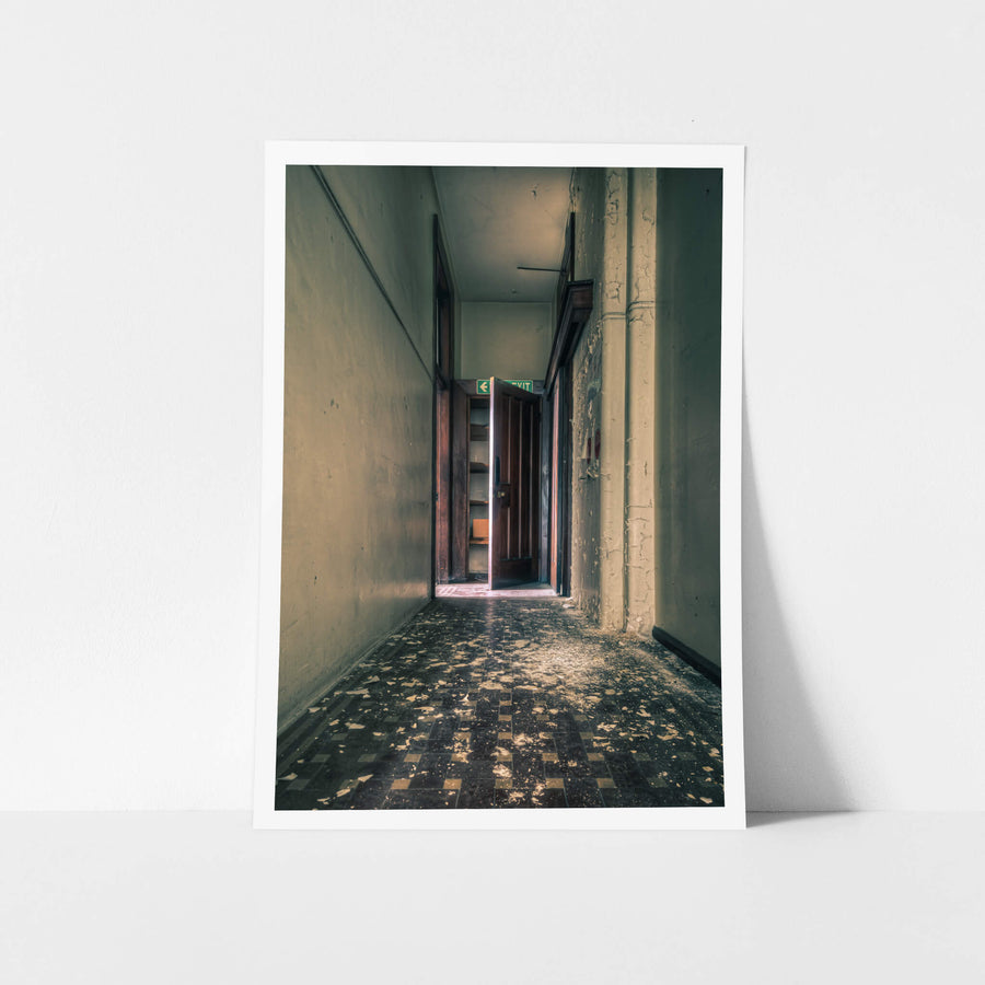 Exit at Lewisham Hospital, a narrow corridor leads to a heavy timber door, swung half open.