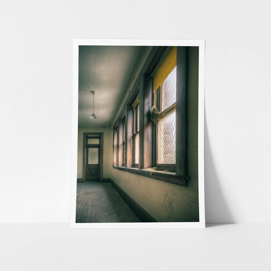 Torn at Lewisham Hospital, afternoon light presses through textured glass, warming the timber window frames to a deep amber.