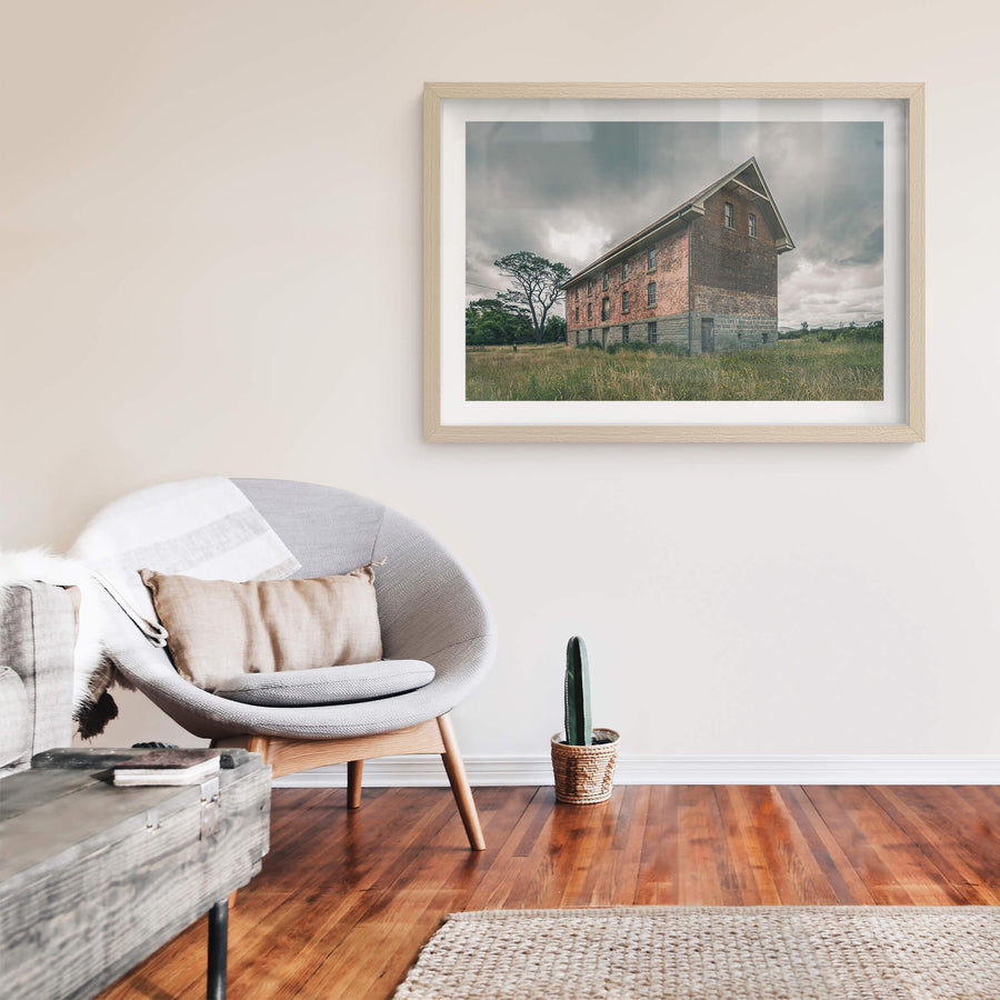 End of the Mill at Mill Pond Farm, a two-storey brick and bluestone building stands alone in open grassland.